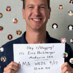 Eric Hochberger, Mediavine CEO, holding a sign announcing an AMA on r/blogging on Wednesday, September 17, at 10 AM EST. He is surrounded by various Reddit avatars, indicating a community event.